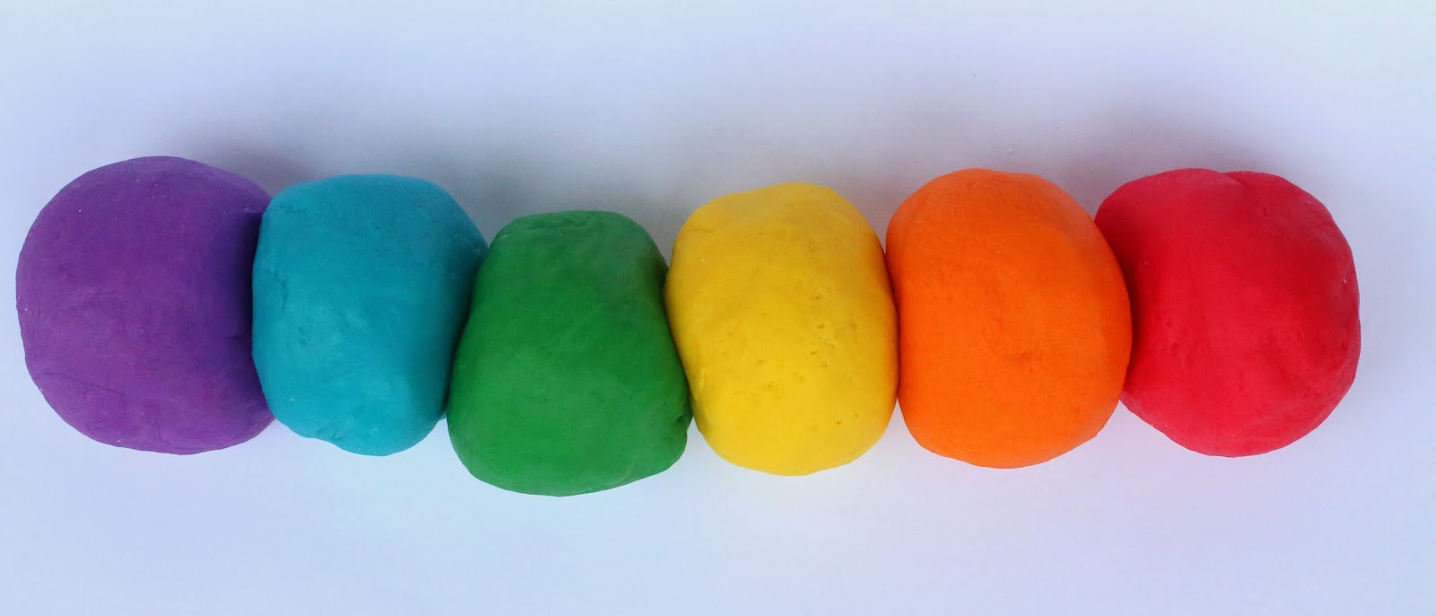 Balls of colored dough in a row