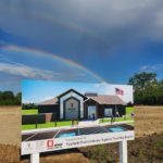 A double rainbow arches over the "Future Home of the Ypsilanti District Library-Superior Township Branch" sign.